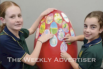 CREATIVE: St Patrick’s Primary School students Greta Thomas, left, and Charli Pickering help decorate one of 18 eggs located across Stawell during the Easter holidays.
