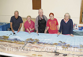 TOGETHER: From left, Ray Colvin, Loretta Emerson, Don Sharples, Gill Venn and Isabelle Martin of the Gariwerd Artists group work on a giant piece titled ‘The Sky’s the Limit’ ahead of their Easter exhibition ‘Art is in the Air’. Picture: COLIN MacGILLIVRAY