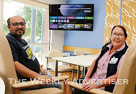 GRATEFUL: Wyuna nurse unit manager Kerri Chamberlain, right, and Cellarbrations Horsham manager Mukesh Bhutani try out new chairs and a 65-inch television purchased with money donated to Grampians Health Horsham by Cellarbrations.