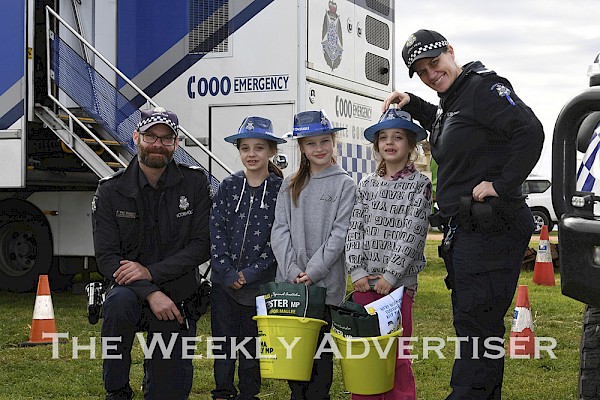 ON THE JOB: Wimmera Proactive Policing squad members, Senior Constables Max Mudge, Stawell, and Deb King, Hopetoun, with triplets Lillian, Charlee and Scarlett Shine.