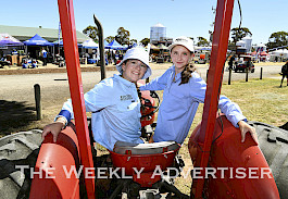 TESTED: Myah Meadows, left, and Lexie Hallam visit the historic equipment on site for the 60th anniversary of the Wimmera Machinery Field Days.