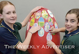 CREATIVE: St Patrick’s Primary School students Greta Thomas, left, and Charli Pickering help decorate one of 18 eggs located across Stawell during the Easter holidays.