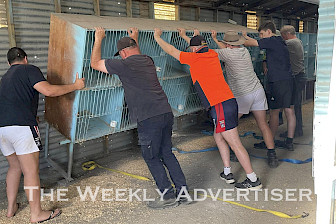 ALL HANDS ON DECK: Wimmera Poultry Club members remove pens from their former Horsham base to take to their new home at Natimuk.