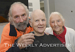 FAMILY AFFAIR: Don Timmins shaves his sister Catherine Olston’s hair at Wimmera Cancer Clinic, as their mother Gwen Timmins watches on. Picture: PAUL CARRACHER