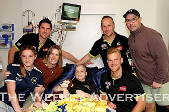 A DAY TO REMEMBER: Horsham’s Fletcher Dandy, centre, welcomed some special visitors during his latest visit to Melbourne’s Royal Children’s Hospital while he undergoes treatment for leukaemia. Top-level football umpires, from left, Matt Stevic, Ray Chamberlain and Nathan Williamson stopped by to visit Fletcher and his family, parents Samara and Simon Dandy and sister Kirrily, putting smiles on faces during a difficult time.  Picture: AFL MEDIA