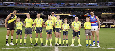 umpire recognition: At the Richmond and Western Bulldogs match on Saturday night, Wimmera umpires were recognised for their contribution to the game. Pictured, from left, Richmond’s Toby Nankervis, Zack Pickering, Harry Foster, Harry Adams, Nate Bacon, Kirrily Dandy, Lenny Bacon, Frank Marklew, Maverick Adams, and Bulldogs captain Marcus Bontempeili. Picture: AFL Photos via Getty Images