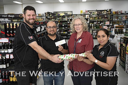 Dean Frew, Mukesh Bhutani and Pooja Bhutani donte $5000 to Wimmera Health Care Service's Judy Wood to buy an observation monitor for Oxley Ward.