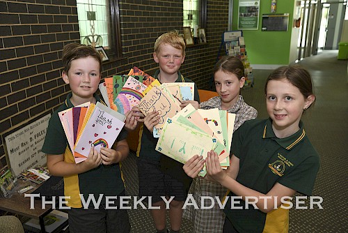 Ss Michael and John's Primary School Grade 3-4  students Archie Dickinson, Jack Robertson, Claudia Penny and Stevie Tucker with cards made by the school's Grade 3-4 students to give thanks to supermarket employees during the COVID-19 crisis.