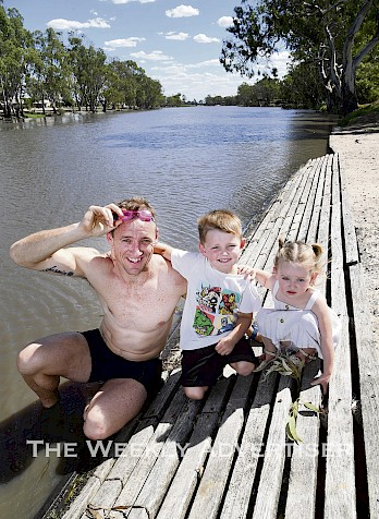 Sam Anson, pictured with his children Jaijai, 5, and Tigerlily, 2, will swim 50km in the Wimmera River between Sawyer Park and Horsham Weir.